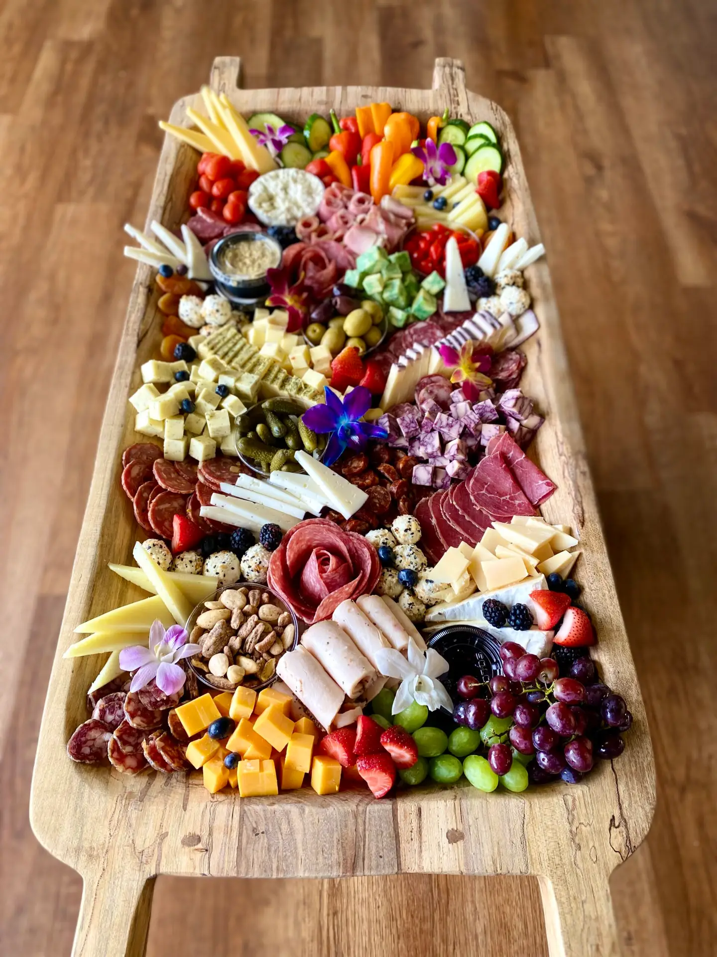 Overhead view of a BYOB charcuterie board with assorted cheeses, meats, fruits, and garnishes in Columbia SC