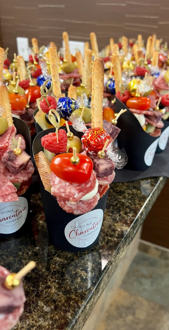 Display of gourmet charcuterie cups arranged for event catering