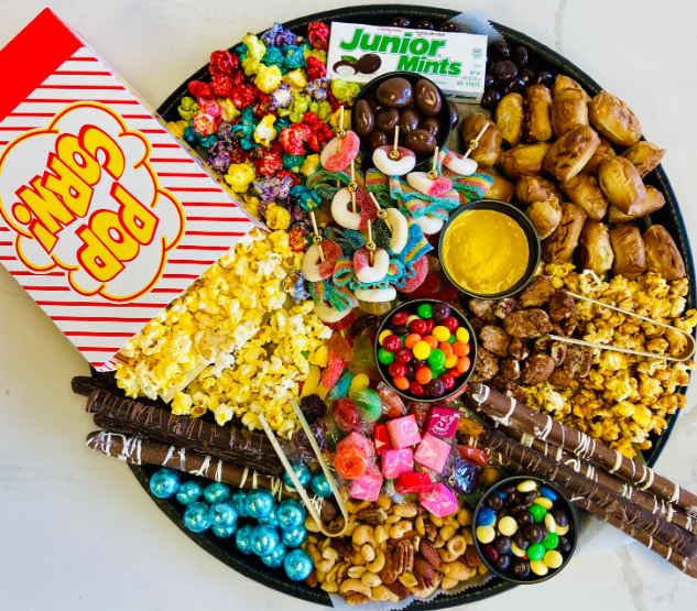 Movie night charcuterie snack tray with popcorn, candy, and treats by Carolina Charcuterie Company